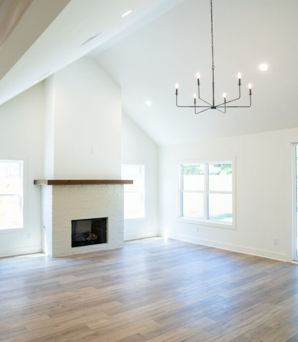 Vaulted living room ceiling with brick fireplace